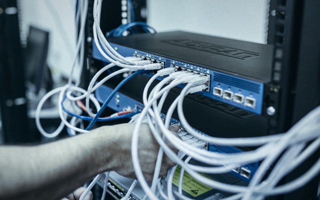 Engineer cabling a rack-mounted security appliance